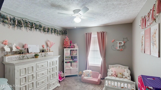 carpeted bedroom featuring ceiling fan and a textured ceiling