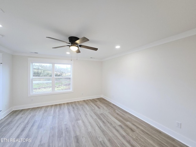 spare room with ornamental molding, ceiling fan, and light wood-type flooring