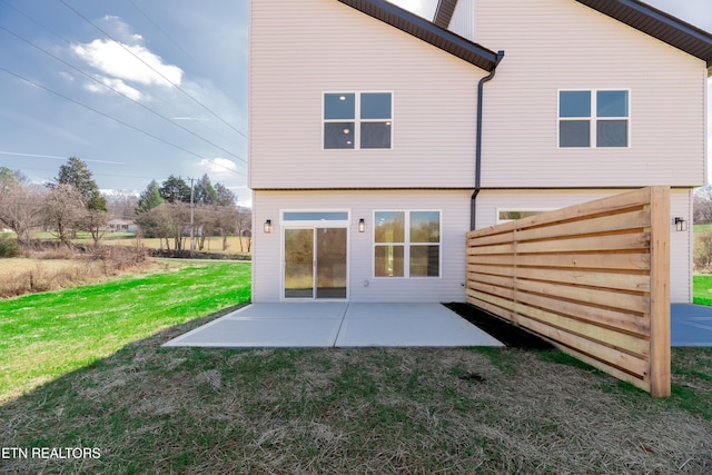 back of property featuring a yard and a patio