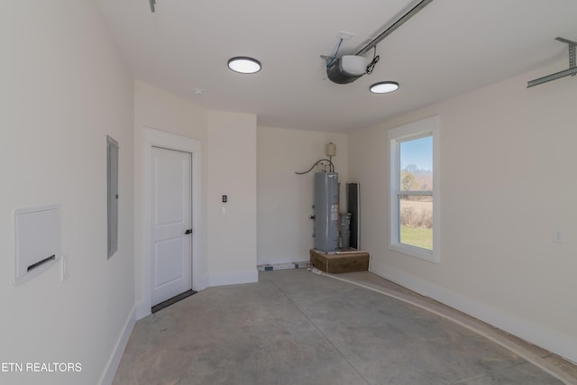 garage with a garage door opener, electric panel, and water heater