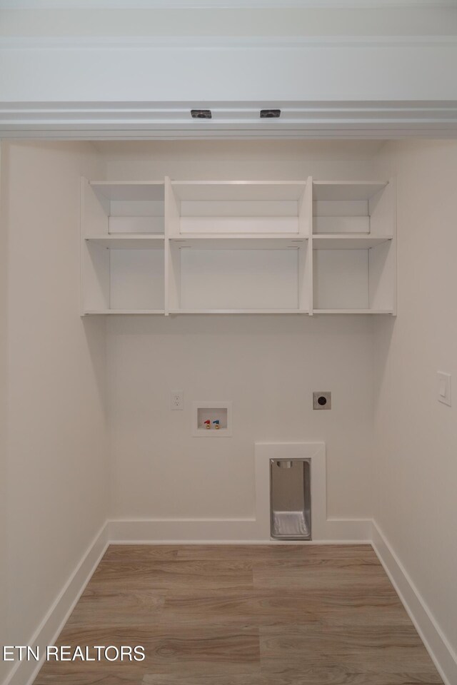 washroom featuring washer hookup, hardwood / wood-style flooring, hookup for an electric dryer, and gas dryer hookup