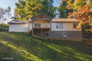 rear view of property with a lawn