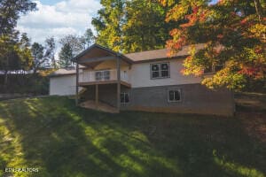 rear view of property with a lawn