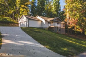 view of front of property with a front yard and a garage