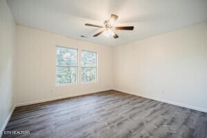 spare room featuring dark hardwood / wood-style flooring