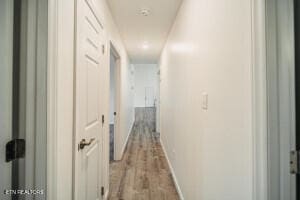 corridor with light hardwood / wood-style floors