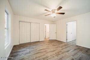 unfurnished bedroom featuring a closet, ceiling fan, and hardwood / wood-style floors