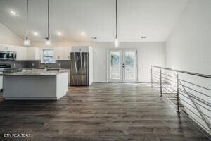 kitchen with a center island, french doors, pendant lighting, white cabinets, and appliances with stainless steel finishes