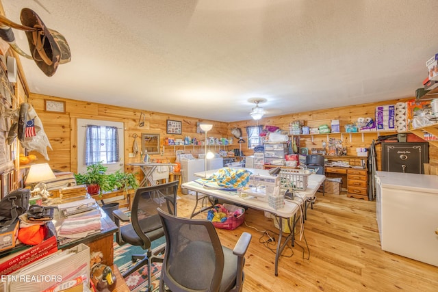 dining area with wooden walls and light hardwood / wood-style flooring