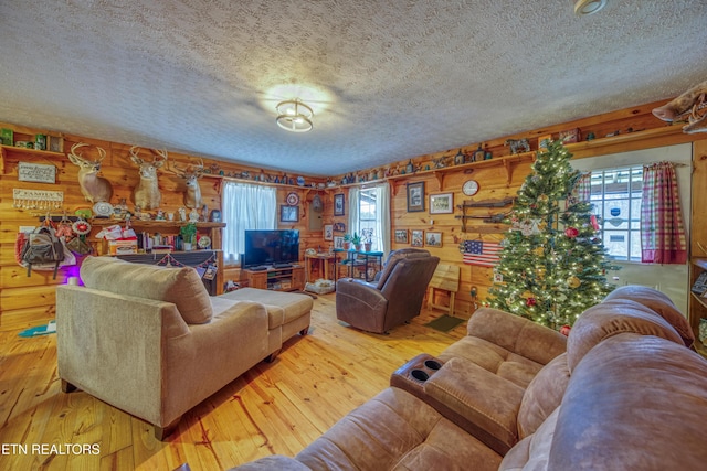 living room with log walls, a textured ceiling, and hardwood / wood-style flooring