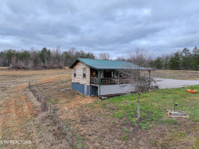 view of outbuilding with a rural view and a lawn