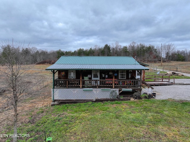 exterior space featuring covered porch and a yard