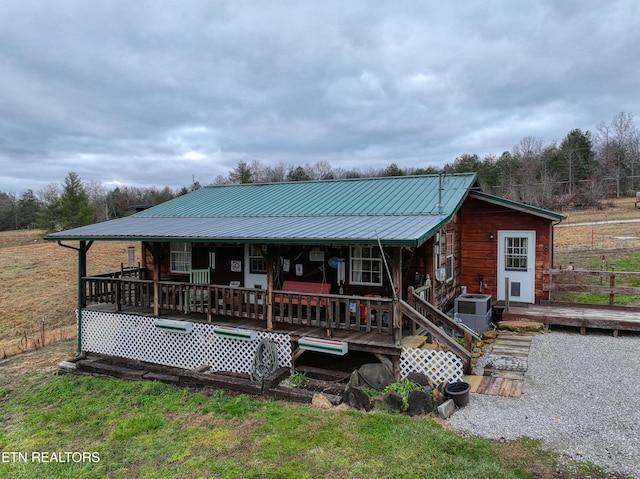 rear view of property with covered porch and central air condition unit