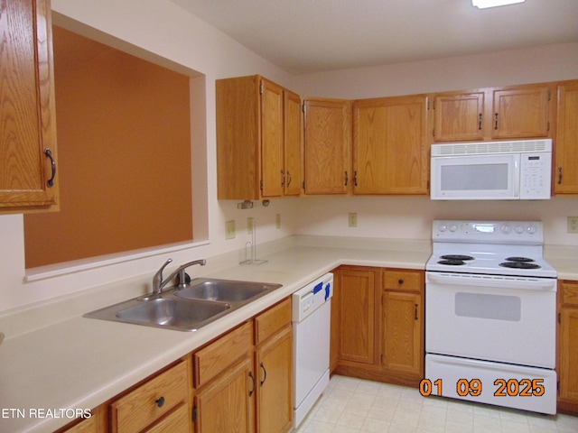 kitchen featuring white appliances and sink