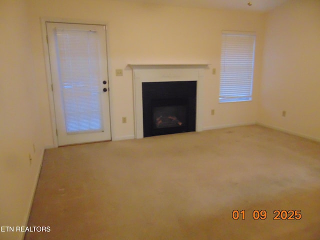 unfurnished living room featuring carpet floors