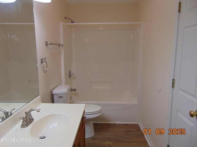 full bathroom featuring hardwood / wood-style floors, vanity, toilet, and shower / tub combination