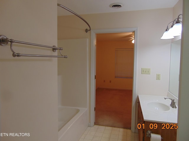 bathroom featuring vanity and  shower combination