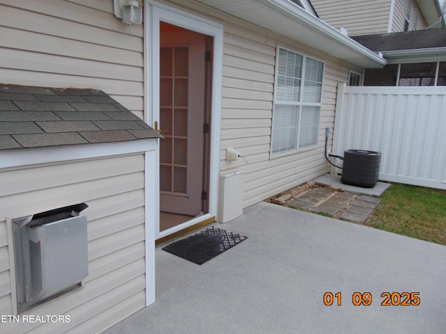 doorway to property with central AC unit and a patio