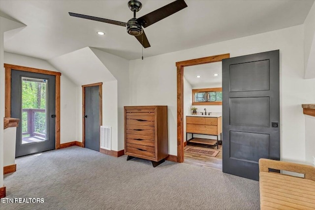 bedroom featuring access to outside, sink, ensuite bath, ceiling fan, and light colored carpet