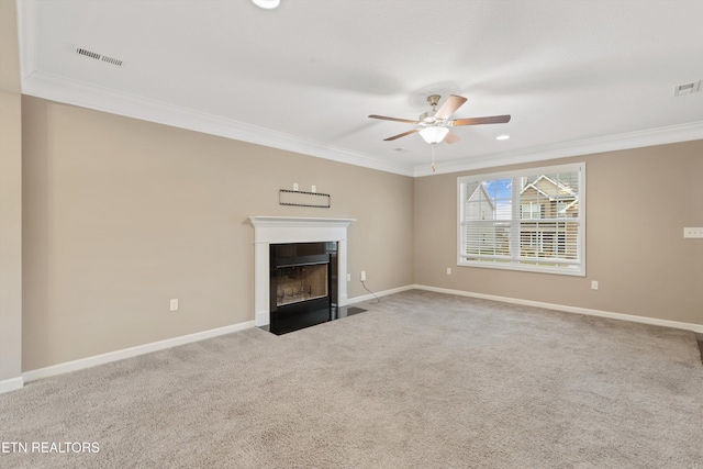 unfurnished living room featuring crown molding, carpet flooring, and ceiling fan