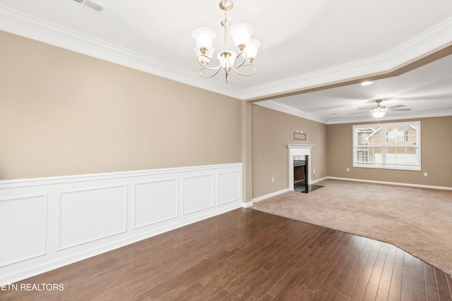 unfurnished living room with hardwood / wood-style floors, crown molding, and ceiling fan with notable chandelier