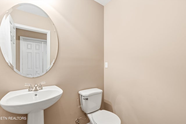 bathroom featuring sink and toilet