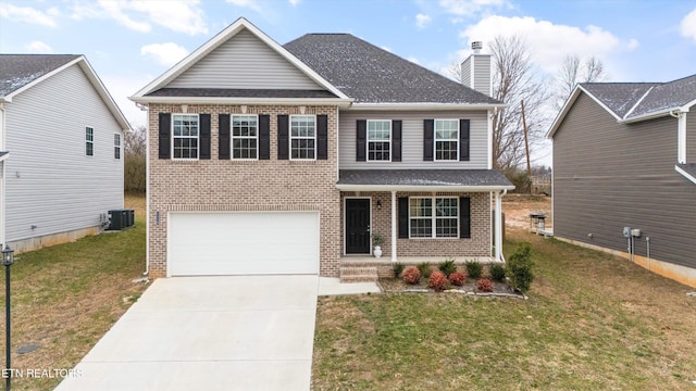 view of front facade featuring a garage, central AC unit, and a front yard