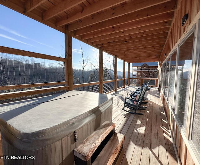 wooden deck with a hot tub