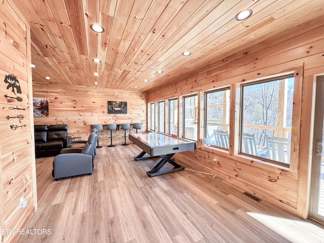 rec room with plenty of natural light, wood ceiling, visible vents, and wood finished floors