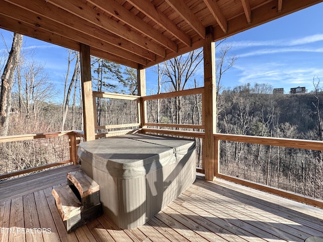 wooden deck with a hot tub