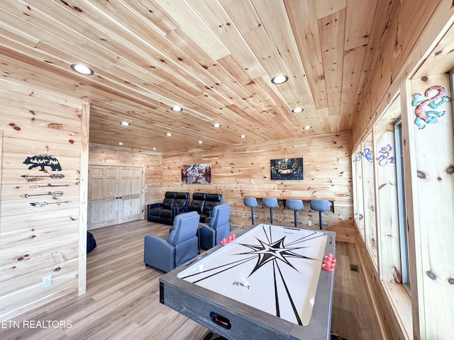 recreation room with recessed lighting, wood walls, wood finished floors, visible vents, and wood ceiling