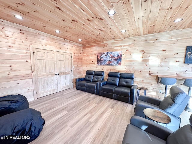 living room with wood walls, light wood-type flooring, wood ceiling, and recessed lighting