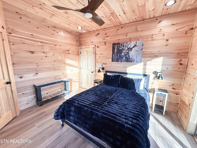 bedroom featuring wood walls, wood ceiling, and wood finished floors