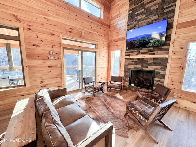 living area featuring wood walls and light wood-style flooring