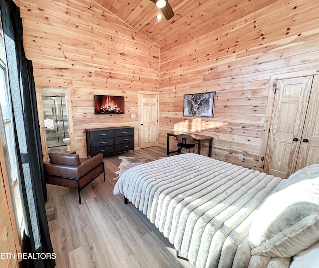 bedroom featuring high vaulted ceiling, wooden ceiling, light wood-style flooring, and wooden walls