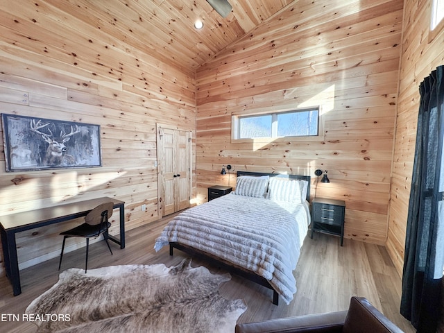 bedroom featuring high vaulted ceiling, wood walls, wooden ceiling, and wood finished floors