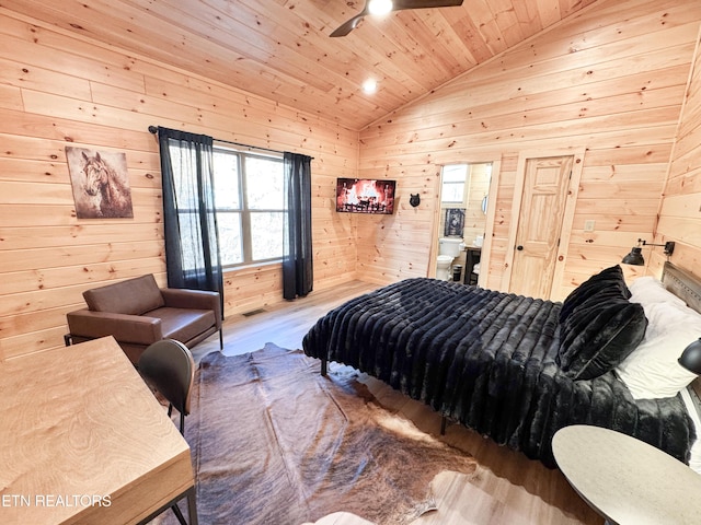 bedroom featuring lofted ceiling, wooden ceiling, wooden walls, and wood finished floors