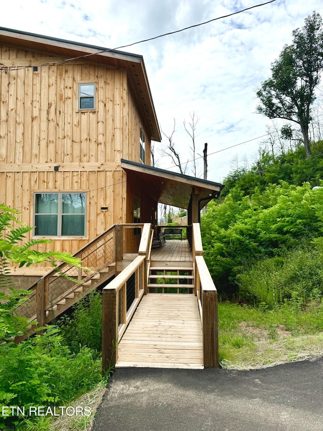 exterior space with stairway and board and batten siding