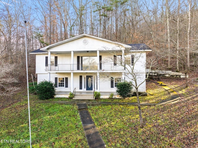 view of front of property with covered porch and a balcony