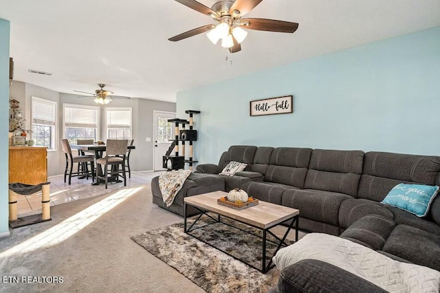 living room featuring light carpet and ceiling fan