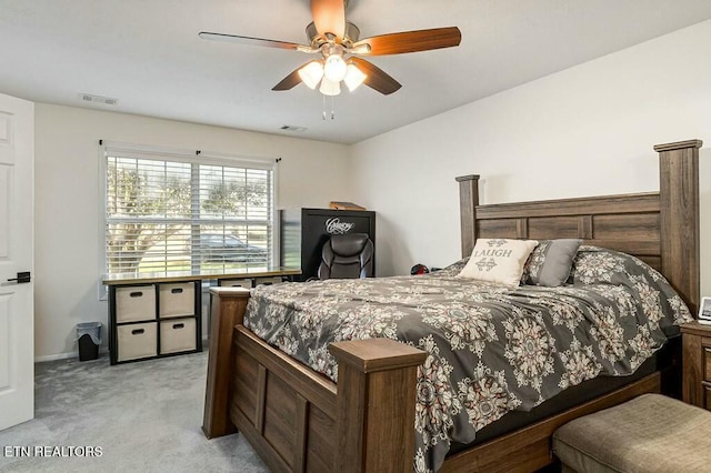 bedroom with ceiling fan and light carpet