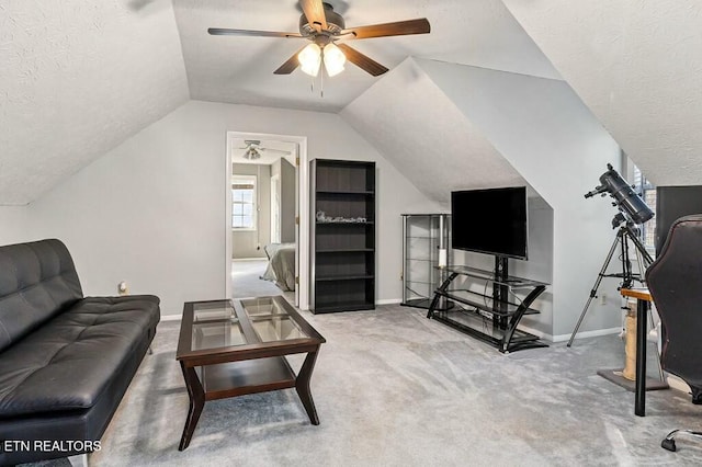 carpeted living room featuring a textured ceiling, ceiling fan, and lofted ceiling