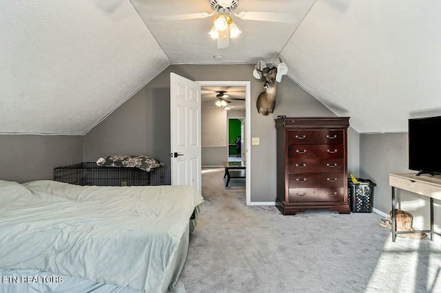 carpeted bedroom with ceiling fan and lofted ceiling