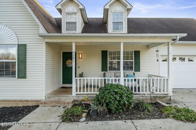 property entrance with covered porch and a garage