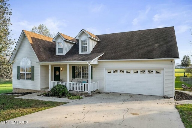 new england style home with covered porch and a garage