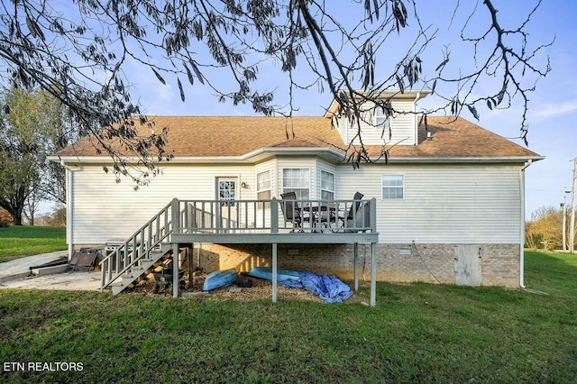 back of house with a wooden deck and a yard