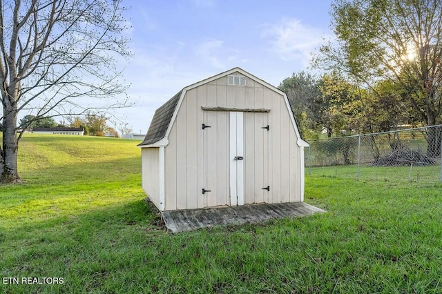 view of outbuilding featuring a lawn