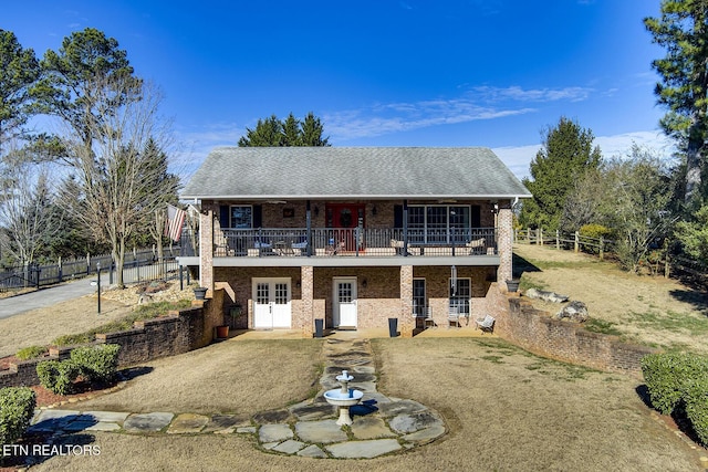 view of front of home featuring a balcony