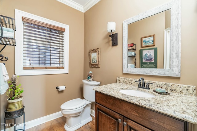 bathroom with crown molding, vanity, toilet, and hardwood / wood-style floors