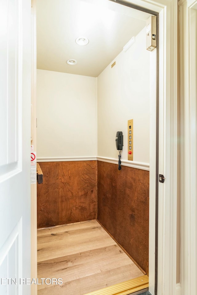 interior space featuring wood-type flooring and elevator